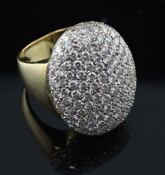 A modern 18ct gold and pave set diamond oval dress ring, size O.